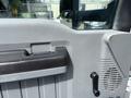 Close-up of the interior door handle and control panel of a 2016 Ford F-750 showing textured surfaces and a speaker grill