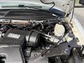 A 2020 Chevrolet Express engine with various components visible including hoses a reservoir and the engine cover