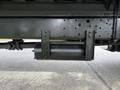 A black air tank mounted on a metal bracket beneath a 2017 Hino 338 truck chassis