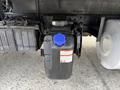 A diesel exhaust fluid tank with a blue cap attached to a Hino 195 truck