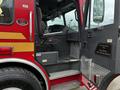 The interior steps and driver's seat of a 2009 Spartan Gladiator fire truck featuring a custom built sign for the Kelowna Fire Department
