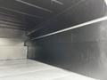 A 2013 Ford F-650 truck interior showing a black metal cargo area with smooth horizontal walls and a flat floor