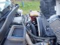 Engine compartment of a 2014 International Durastar showing various components including hoses and a coolant reservoir