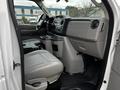 Interior view of a 2011 Ford Econoline showing the driver's seat dashboard and center console with cup holders and controls