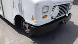 A white 2011 Ford Econoline with a damaged front grille and a flat tire is prominently displayed in the image