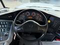 Interior view of a 2015 International 3000 bus dashboard featuring a black steering wheel and various gauges and controls