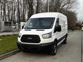 A white 2017 Ford Transit van with a black grille and large side windows parked on a street