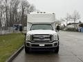 A 2011 Ford F-550 with a white box truck body is parked facing forward