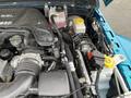 Close-up view of a 2020 Jeep Wrangler engine compartment showcasing various components including the air intake and coolant reservoir