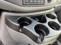 A black plastic cup holder with four compartments designed for a 2008 Ford Econoline