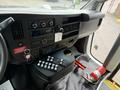 Interior dashboard of a 2020 Chevrolet Express featuring controls for audio climate and various functions with visible ignition key and fire extinguisher