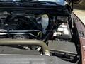Engine compartment of a 2015 RAM 5500 featuring visible components like the alternator battery and coolant reservoir