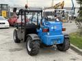 A blue 2020 Genie GTH-5519 telehandler with a black cabin and large rear tires visible from the back angle