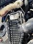 Close-up of the engine compartment of a 2022 Freightliner Cascadia showing the air intake manifold and coolant reservoir
