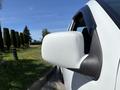 Close-up of the side mirror of a white 2011 Chevrolet Colorado
