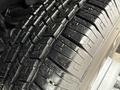 Close-up of a well-worn tire with deep treads on a 2013 Chevrolet Express showcasing signs of use and potential debris on the surface