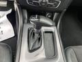 Close-up of the gear shifter in a 2022 Dodge Charger featuring a leather boot and buttons for shifting between drive reverse and neutral