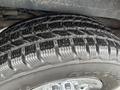 Close-up of a tire on a 2014 Chevrolet Express showcasing its tread pattern and sidewall design