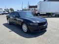 A black 2019 Dodge Charger parked with a sleek design and distinctive front grille showcasing its modern style and sporty features
