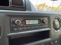 Dashboard control panel of a 2023 Ford E-450 featuring a radio display with FM tuning and various control buttons