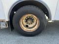 Close-up of a worn Michelin tire mounted on a rusty metal rim of a 2007 International 7300 truck