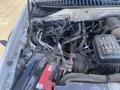 A 2013 Ford Expedition engine compartment showcasing various components including the battery and wiring connections