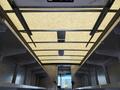 Interior view of a 2012 Ford Econoline van showcasing the ceiling with light panels and empty cargo space on either side