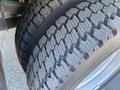 A close-up view of a 2015 Ford F-450 SD tire showcasing its tread pattern and rubber surface