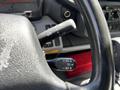 The steering wheel of a 2018 Hino 195 featuring control stalks for cruise control and other functions
