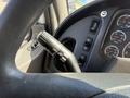 Close-up of a 2015 Freightliner M2 106 steering wheel with controls for wipers turn signals and various dashboard switches
