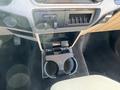 Interior view of a 2014 Ford F-350 SD showing a central console with a retractable cup holder and control buttons