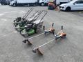Three Honda Lawnboy mowers and two Stihl line trimmers arranged in a row on a flat surface