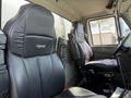 Two black leather seats inside a 2009 International 7500 truck cabin with a visible steering wheel on the right