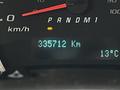 The dashboard of a 2019 Chevrolet Express showing a digital odometer reading 385712 kilometers and a temperature of 13 degrees Celsius