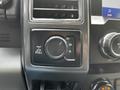 Control panel of a 2020 Ford F-350 Super Duty showcasing a dial for selecting drive modes including options for 2H 4H and 4L