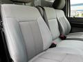 The interior of a 2016 Ford F-550 featuring gray fabric seats with a textured pattern and seat belts attached