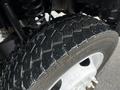 Close-up of a 2014 Ford F-550 tire showcasing detailed tread pattern and metallic wheel rim