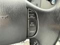 Close-up of the steering wheel controls of a 2011 Ford F-650 with buttons for resume, set, accelerate, and coast