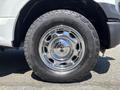 Close-up of a chrome wheel and tire from a 2016 Ford F-150 showing the tread and design of the tire