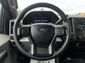 Steering wheel of a 2019 Ford F-550 with the Ford logo in the center and various control buttons on the sides