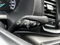 A close-up view of the control stalk in a 2023 Ford Transit featuring various switch settings for lights and windshield wipers