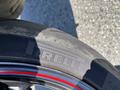 Close-up of a Pirelli motorcycle tire with the brand name and model visible on the sidewall with a distinctive red stripe around the rim of the wheel