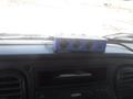 A blue power adapter with multiple sockets and USB ports placed on the dashboard of a 2005 Freightliner M2 106 Medium Duty truck