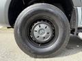 Close-up of a black wheel and tire from a 2019 Mercedes-Benz Sprinter featuring a silver hubcap with the Mercedes-Benz logo