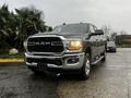 A 2020 RAM 3500 pickup truck with a chrome grille and silver accents parked with visible headlights and a polished exterior