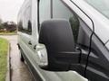 A 2019 Ford Transit van with a close-up of its side mirror showing raindrops on the surface