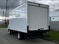 A 2022 Isuzu NPR truck with a white box cargo area and a flatbed rear design