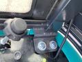 Close-up of a control lever and metal bracket inside the cabin of a 2024 AGT Industrial QH13R Mini Excavator with visible bolts and wiring components