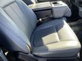 A gray leather front seat with an armrest from a 2013 Ford F-250 SD