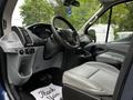 Interior of a 2017 Ford Transit 350 showing the driver's seat steering wheel and dashboard with controls and accessories